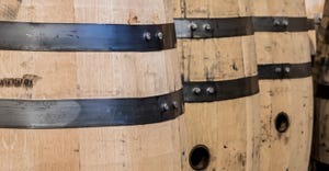 row of wooden bourbon barrels