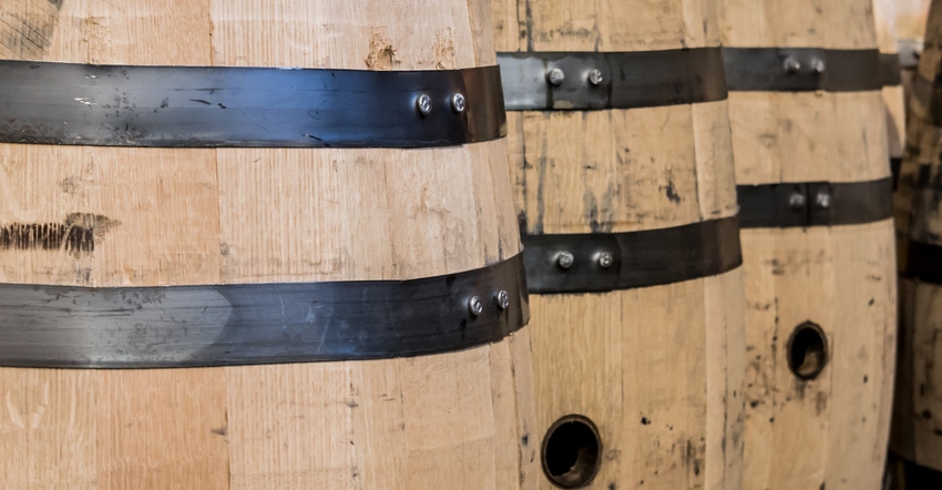 row of wooden bourbon barrels row of wooden bourbon barrels