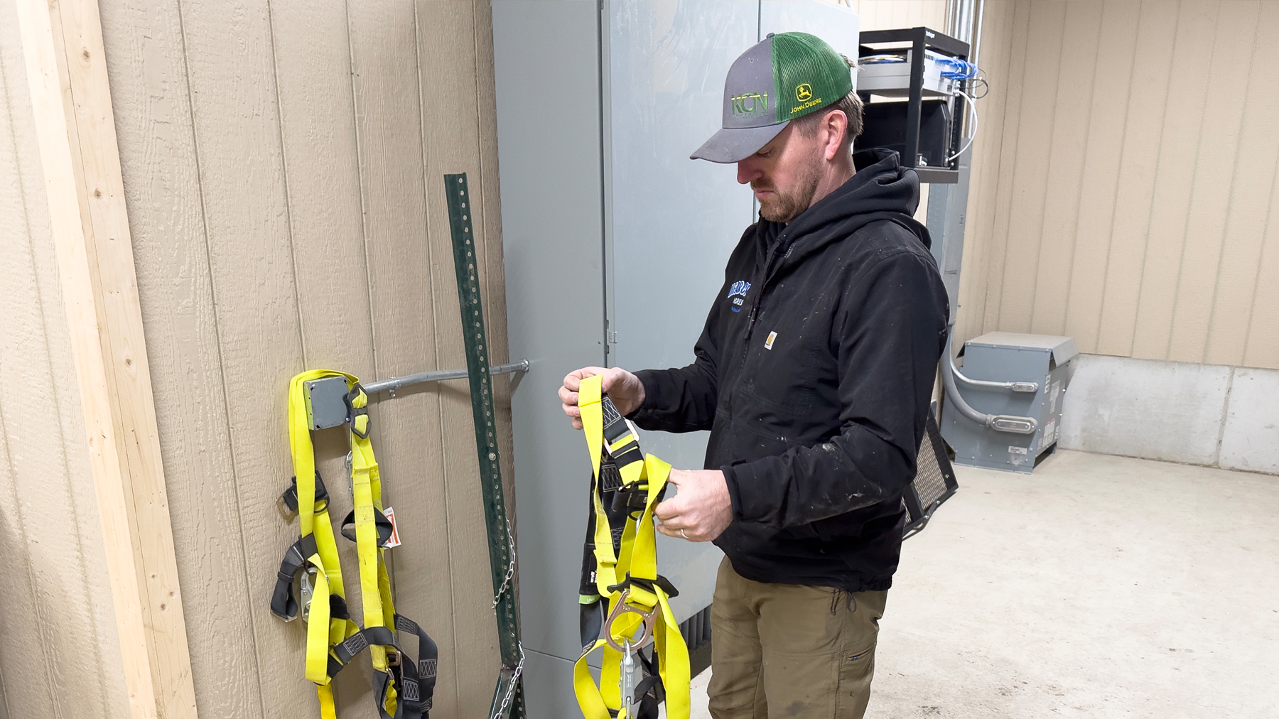 Jack Fehr with safety harnesses required to enter bins at Clear Creek Acres
