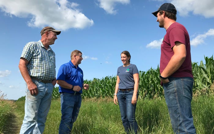 Mark Riestenberg discussing crop progress with Darren Newville, Trisha Demarais and Nathan Wiese