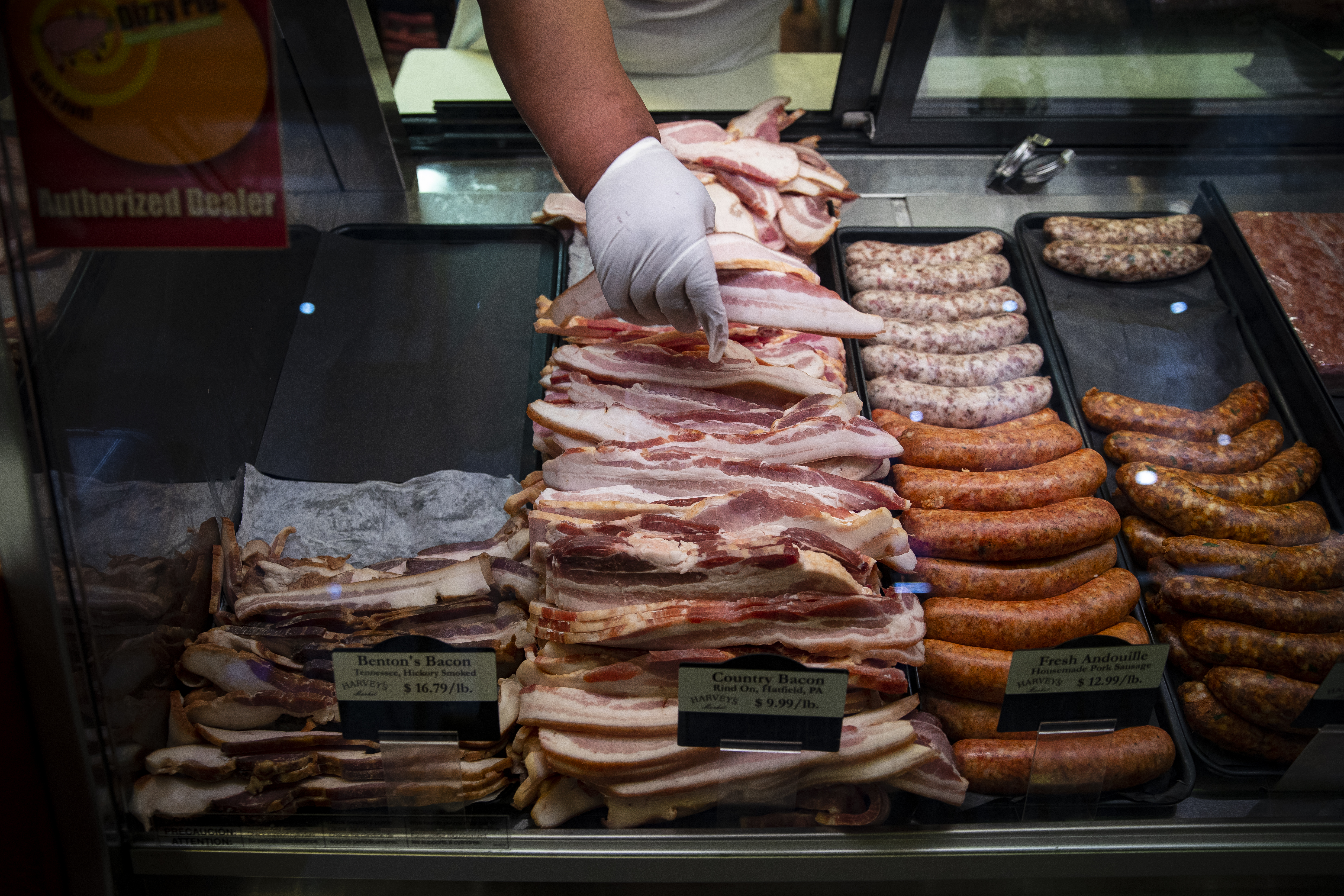 Pork bacon and sausage line a deli case.