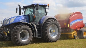 A New Holland tractor pulling a New Holland baler