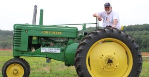 Dave Krump of Eau Claire, Wis., sitting on a 1934 John Deere Model A tractor