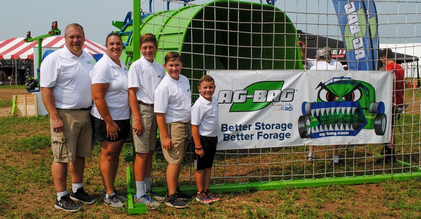 Randy and Wendy Clark show off their new T-7170 Ag-Bag with their three sons Ryan Wisconsin Farm Technology Days 