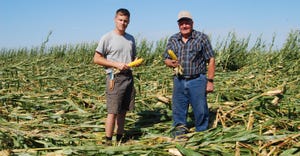  Seth Gerlach (left) inspecting a wind damaged cornfield with his great uncle, Dwayne Gerlach