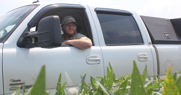 Robert Allen King drives truck past beans