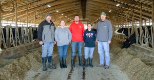 Mark Crandall, Kelley Wagner, Thomas Wagner, Stacey Koy and Brad Crandall stand in a dairy barn