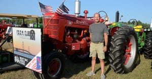 Steve Kittle stands next to a 1950 Farmall M tractor
