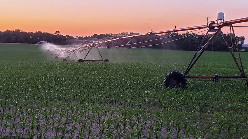 An irrigation system spraying a field of crops