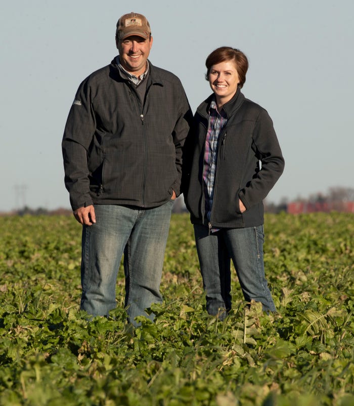 Brian and Jamie Johnson stand in a cover crop