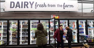 People shop for dairy products at a supermarket