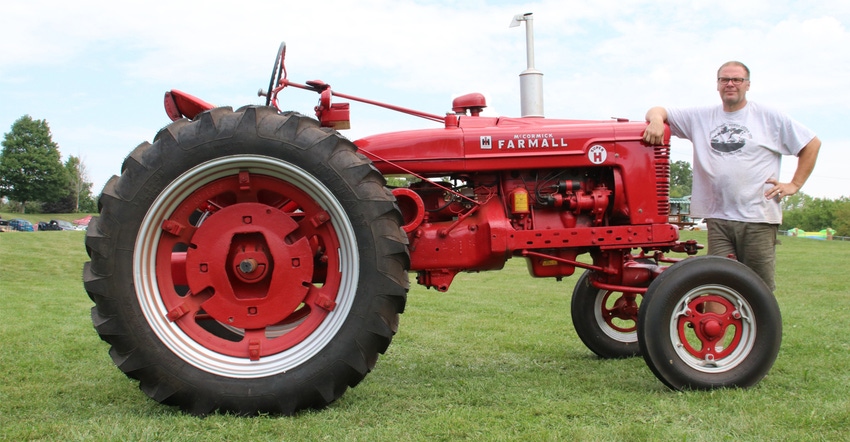Kevin Riemer with Super H Farmall tractor
