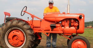Alan Thomley standing with his 1944 model B Allis-Chalmers tractor