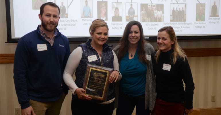 : Boone McAfee, director of research at the Nebraska Corn Board (one of the sponsors of the competition), hands the award for most profitable to the NDEQ team, including L-R: Sam Radford, Laura Johnson, and Carla McCullough