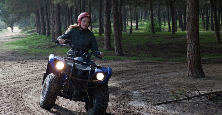 Teenage girl riding ATV