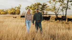 megan and tanner overby in field with cows
