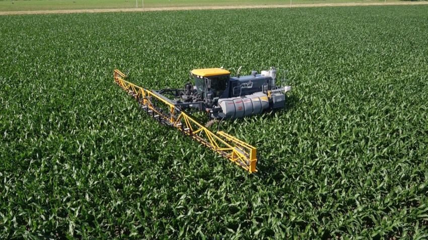 Sprayer applying nitrogen to field
