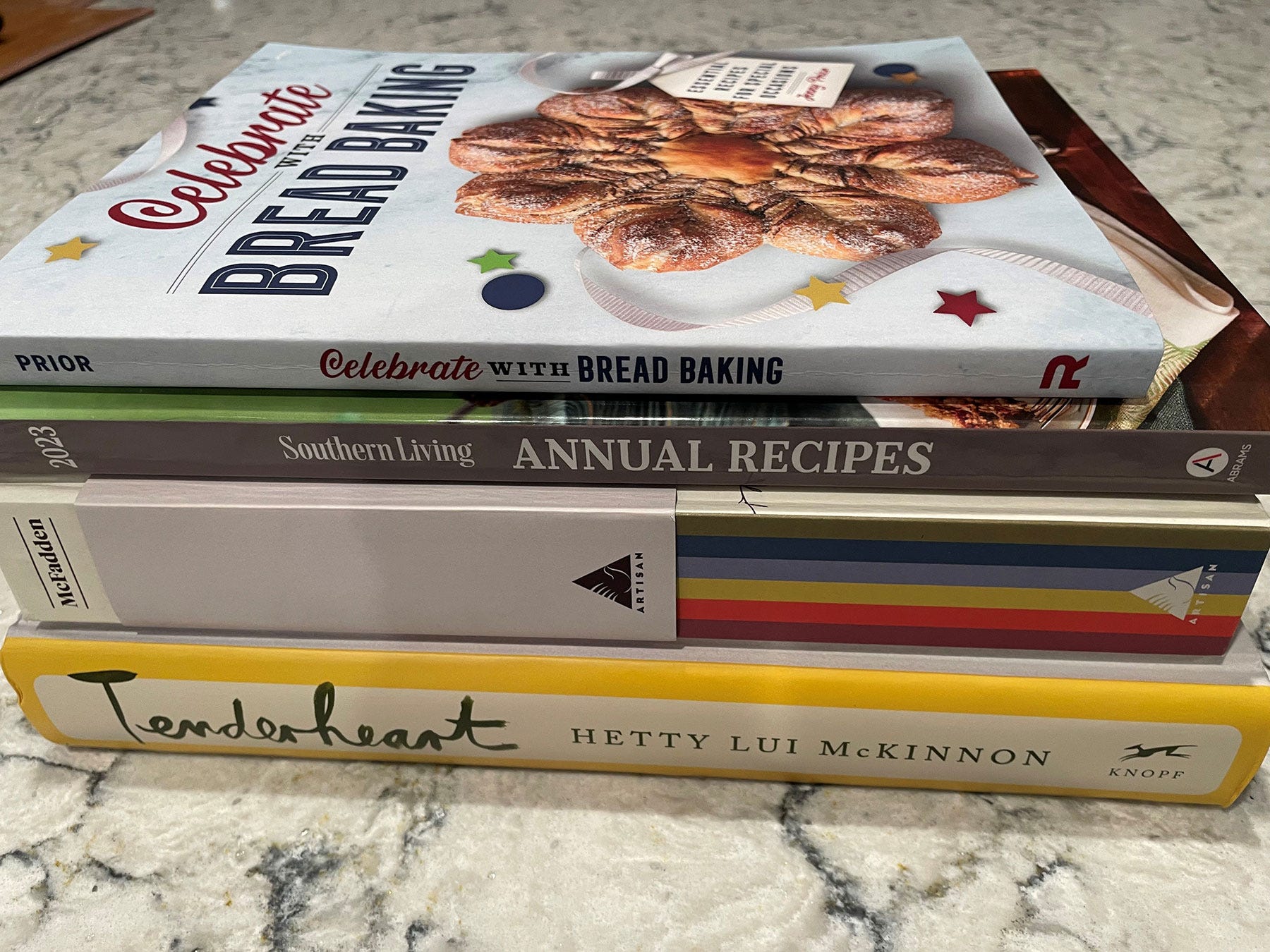 A stack of cookbooks on a counter