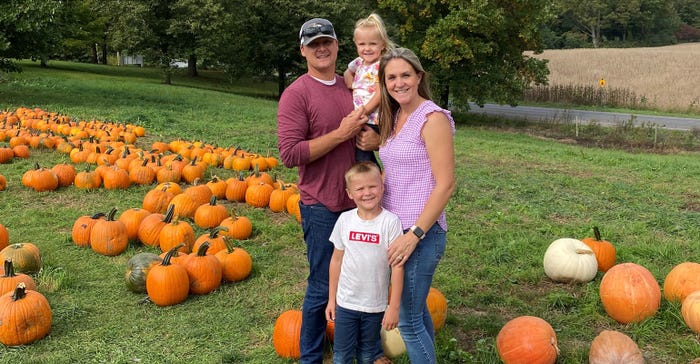 Cade Klein and family standing in front of pumpkins