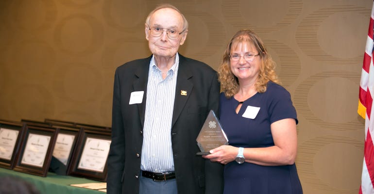Morris Burger receives the inaugural Missouri 4-H Champion Award from Missouri 4-H Foundation trustee Elaine Anderson