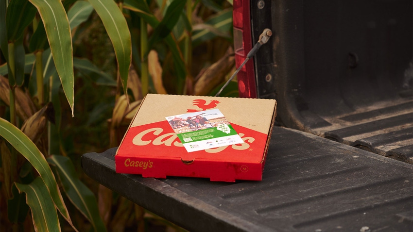 A Casey's pizza box sitting on a tailgate of a pickup truck