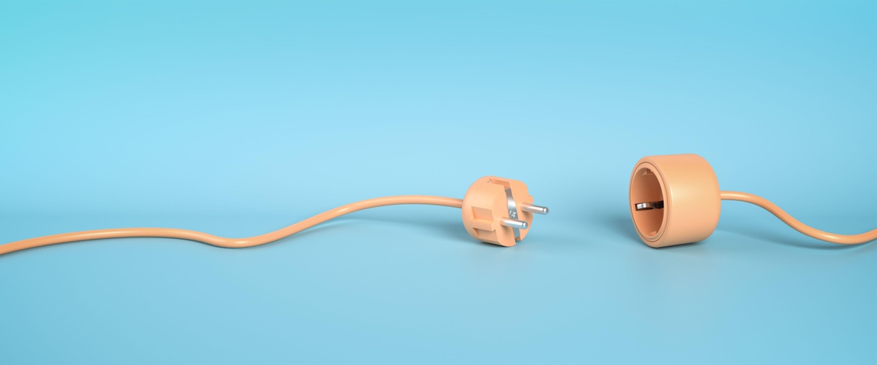 plug and socket unattached. peach-colored wire lying unplugged on light blue background plug and socket unattached. peach-colored wire lying unplugged on light blue background