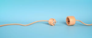 plug and socket unattached. peach-colored wire lying unplugged on light blue background plug and socket unattached. peach-colored wire lying unplugged on light blue background