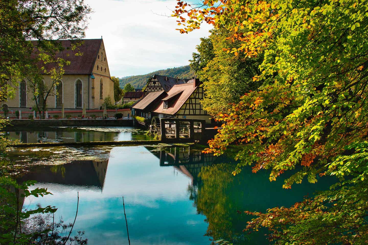 Blick auf ein Restaurant am Wasser vom Blautopf in Ulm