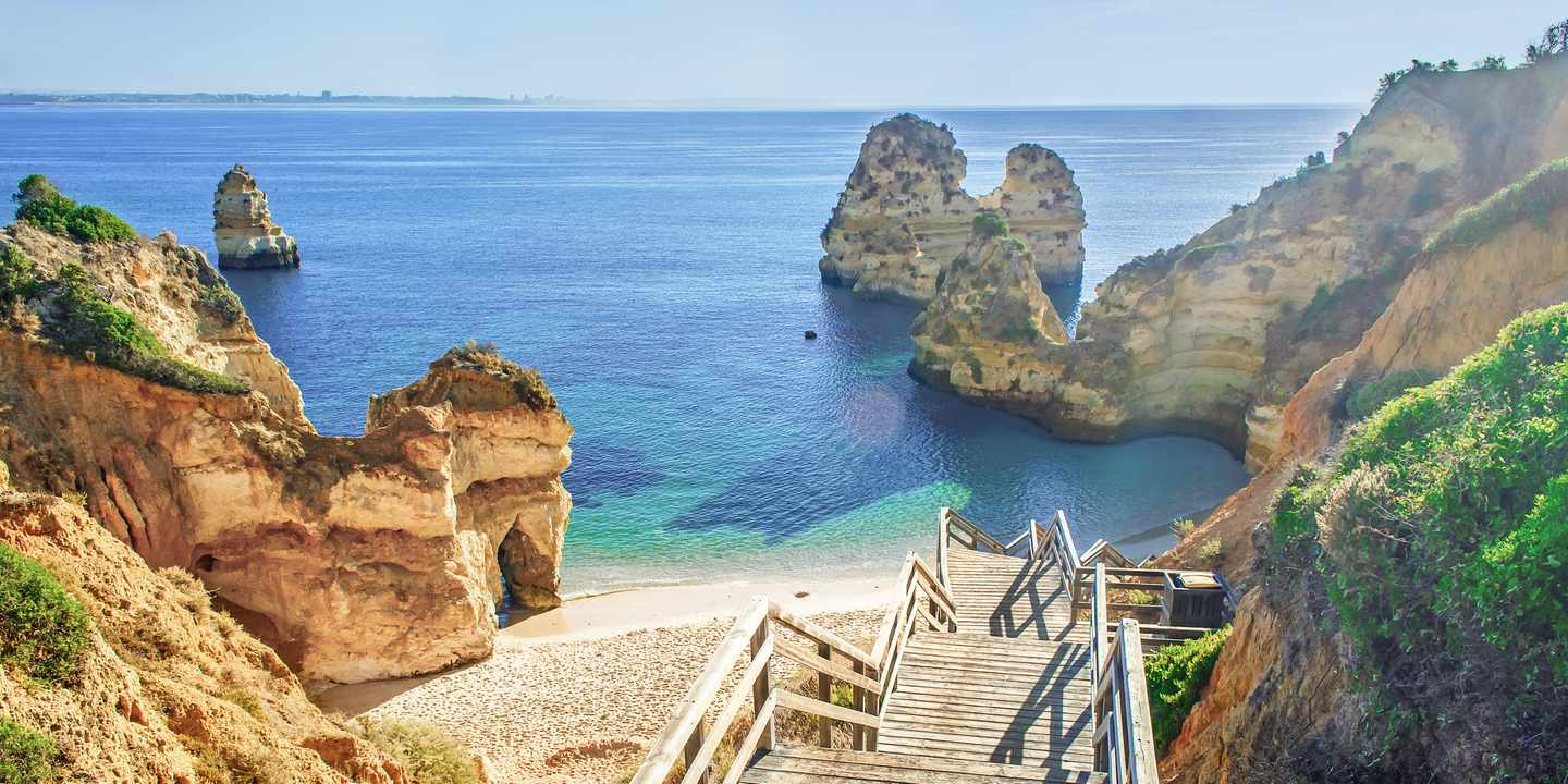 Praia do Camilo bei Lagos – Holztreppe führt zwischen Klippen zum Strand an der Algarve