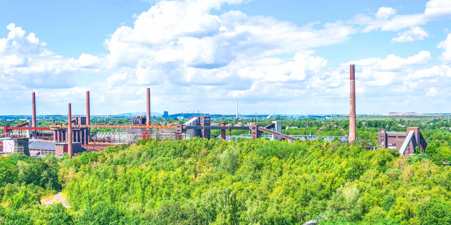 Ein besonderer Roadtrip durch Deutschland führt am Zollverein Essen vorbei, der inmitten grüner Wälder steht