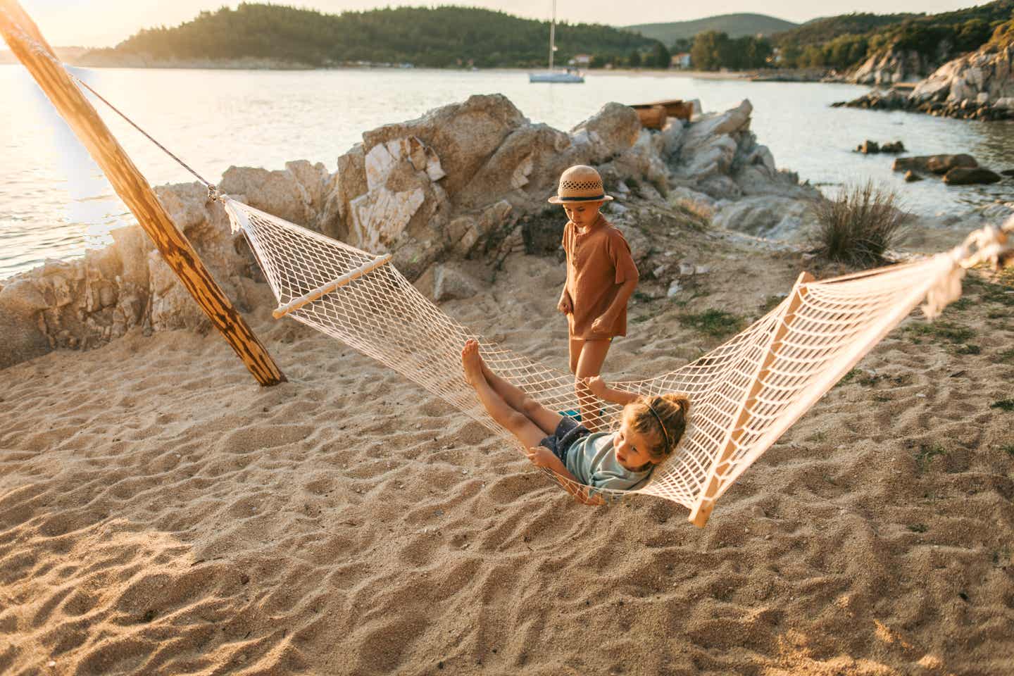 Kinder entspannen in einer Hängematte am Strand auf Chalkidiki im Familienurlaub in Griechenland