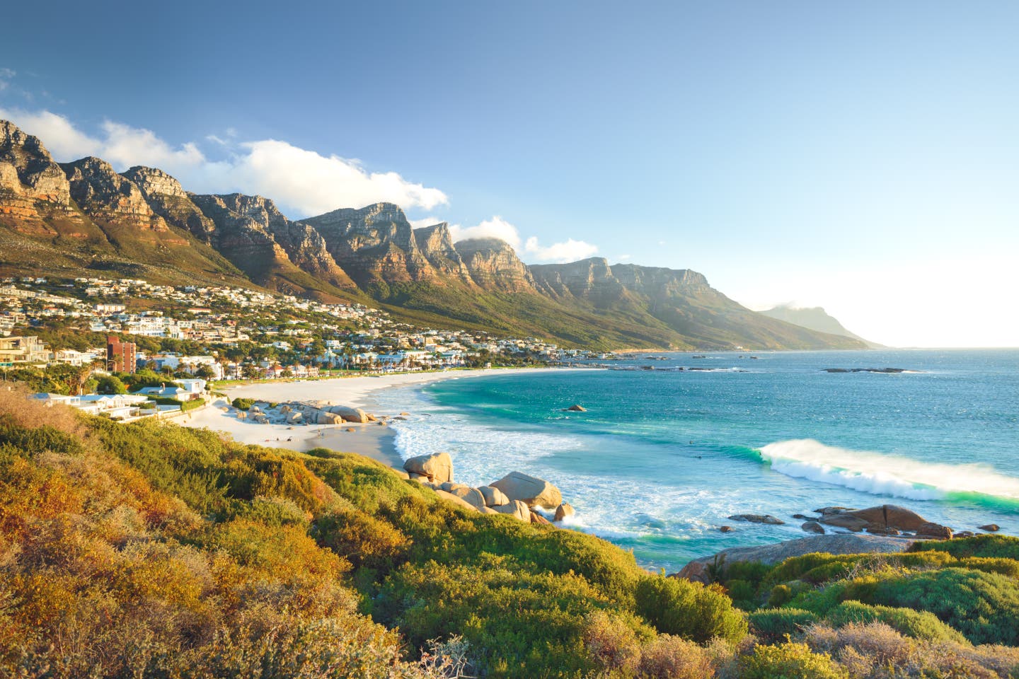 Blick auf den Camps Bay Beach mit der Zwölf-Apostel-Bergkette bei Kapstadt, Südafrika – Meeresbucht im Abendlicht