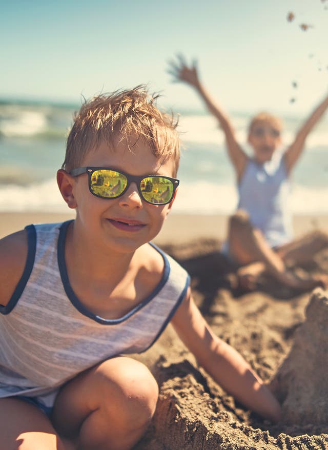Ausflugsziele Italien mit Kindern: Tipps Zwei Jungs spielen am Strand in Italien