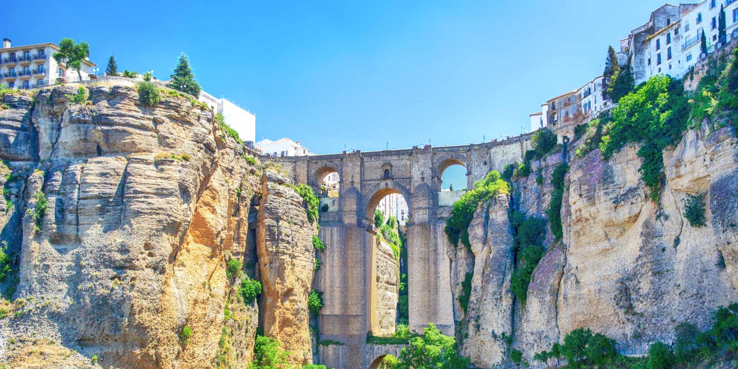 Brücke über den Río Guadalevín, die hoch zwischen den Bergen aufragt