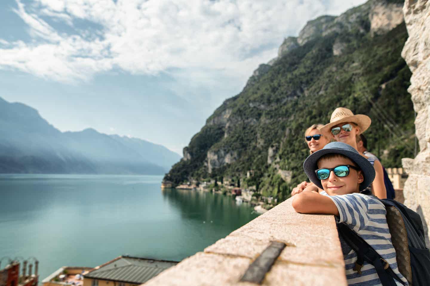 Familie genießt den Ausblick auf Riva del Garda und den Gardasee, umgeben von Bergen, während eines Familienurlaubs am Gardasee