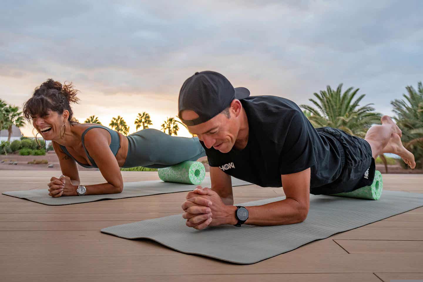 Trainingsreisen: Sportler beim Planken vor einem Palmen-Hintergrund im Playitas Resort