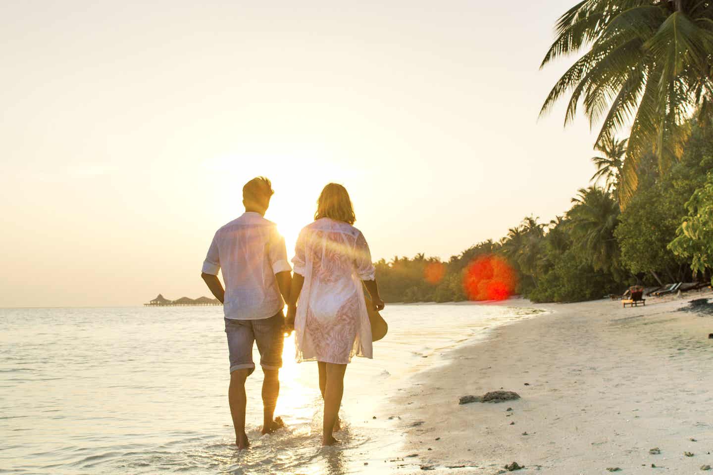 Malediven: Paar am Strand bei Sonnenuntergang