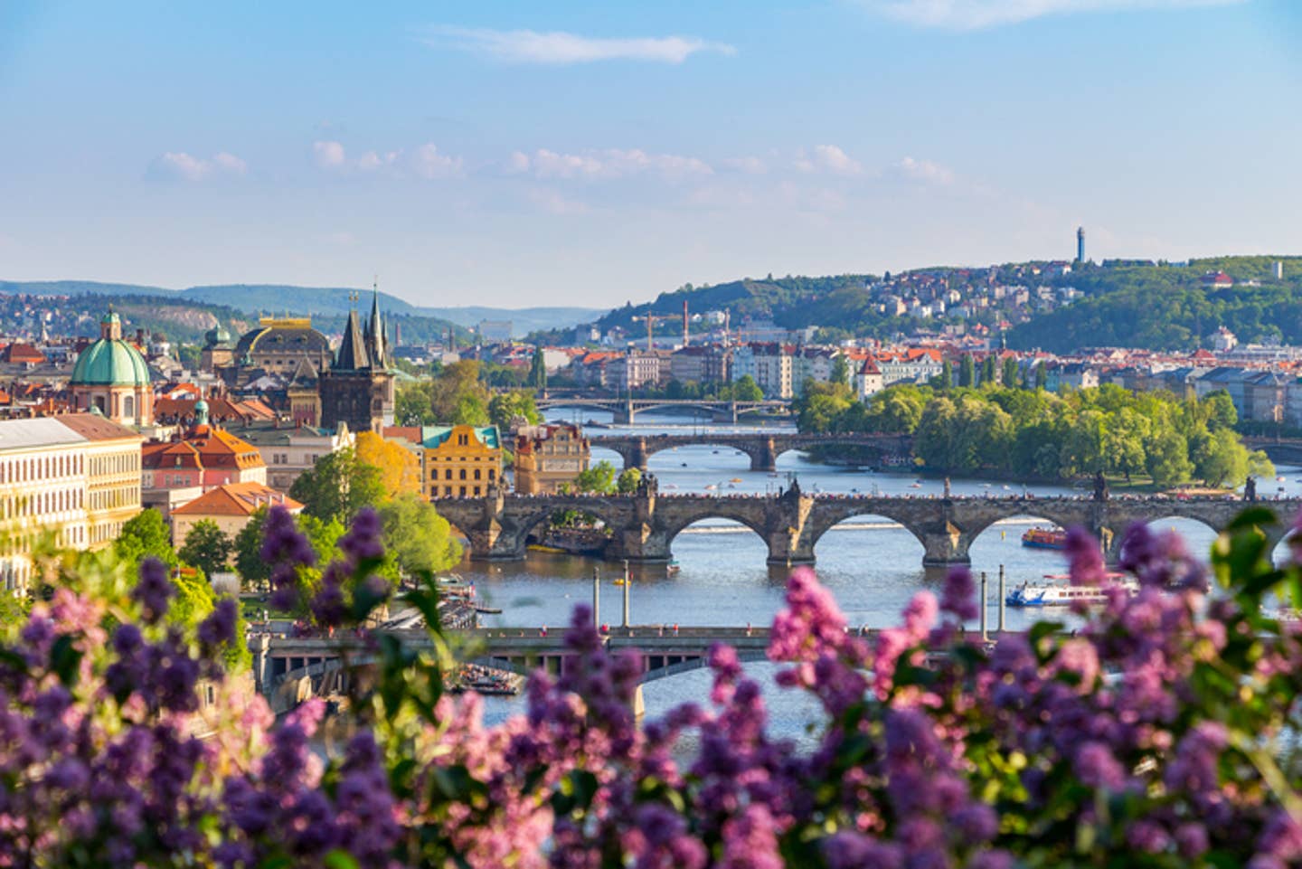 Rundreisen Tschechien: Panoramabild der Hauptstadt Prag mit mehreren historischen Brücken über dem Fluss Moldau