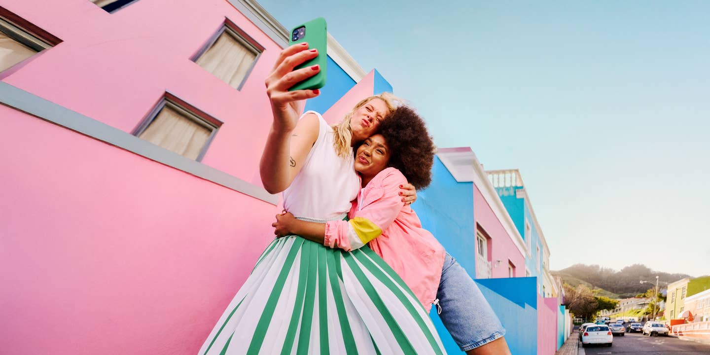 Junges Paar macht Selfie in einer bunten Altstadt