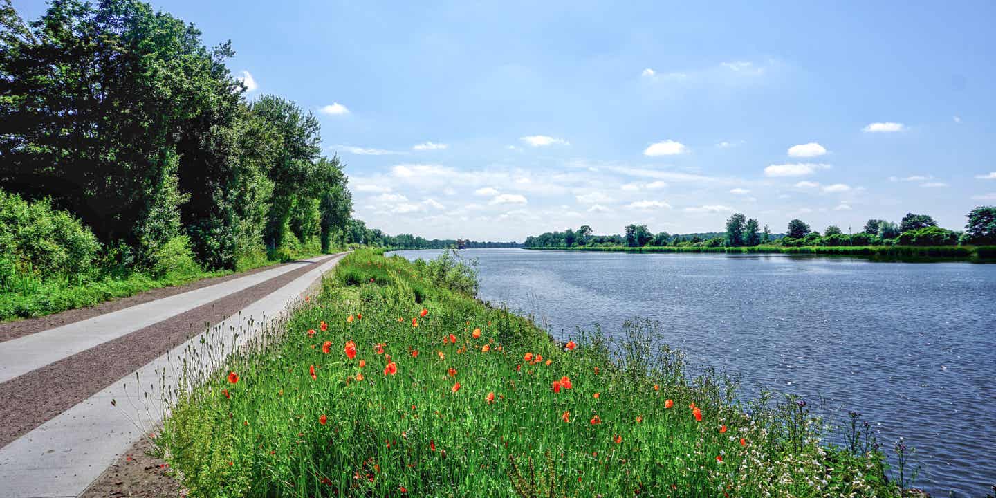 Blick auf den Radweg am Nord-Ostsee-Kanal bei strahlend blauem Himmel