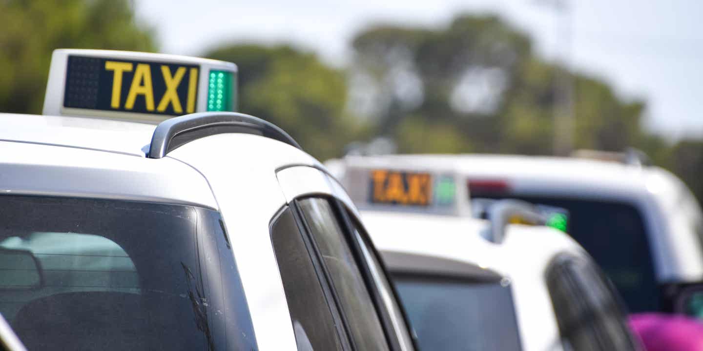 Taxis auf Ibiza mit leuchtendem Schild – beliebte Option für die Fahrt zu Sunset Bars und Stränden