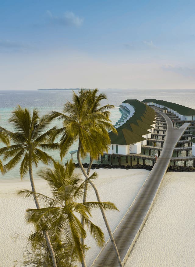 Indischer Ozean Urlaub Wasservillen des Siyam World auf den Malediven mit Palmen im Vordergrund