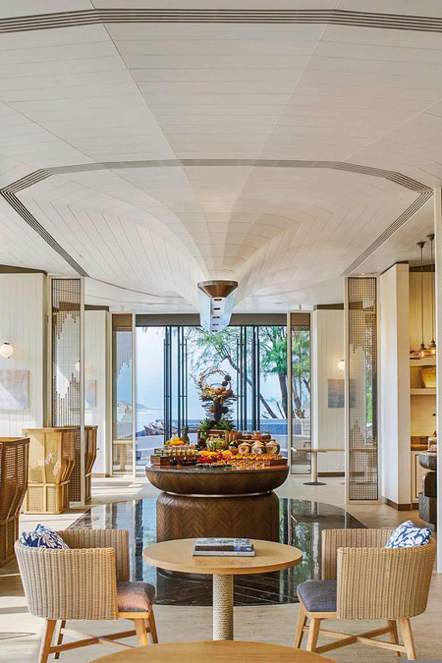 Tisch mit zwei Stühlen und Frühstücksbuffet im Melia Koh Samui
