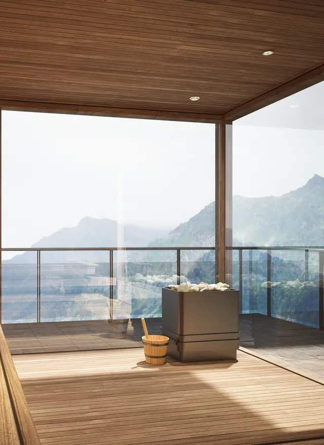 Wellnessurlaub Moderne Sauna mit Panoramablick auf grüne Berglandschaft während eines Wellnessurlaubs in den Bergen