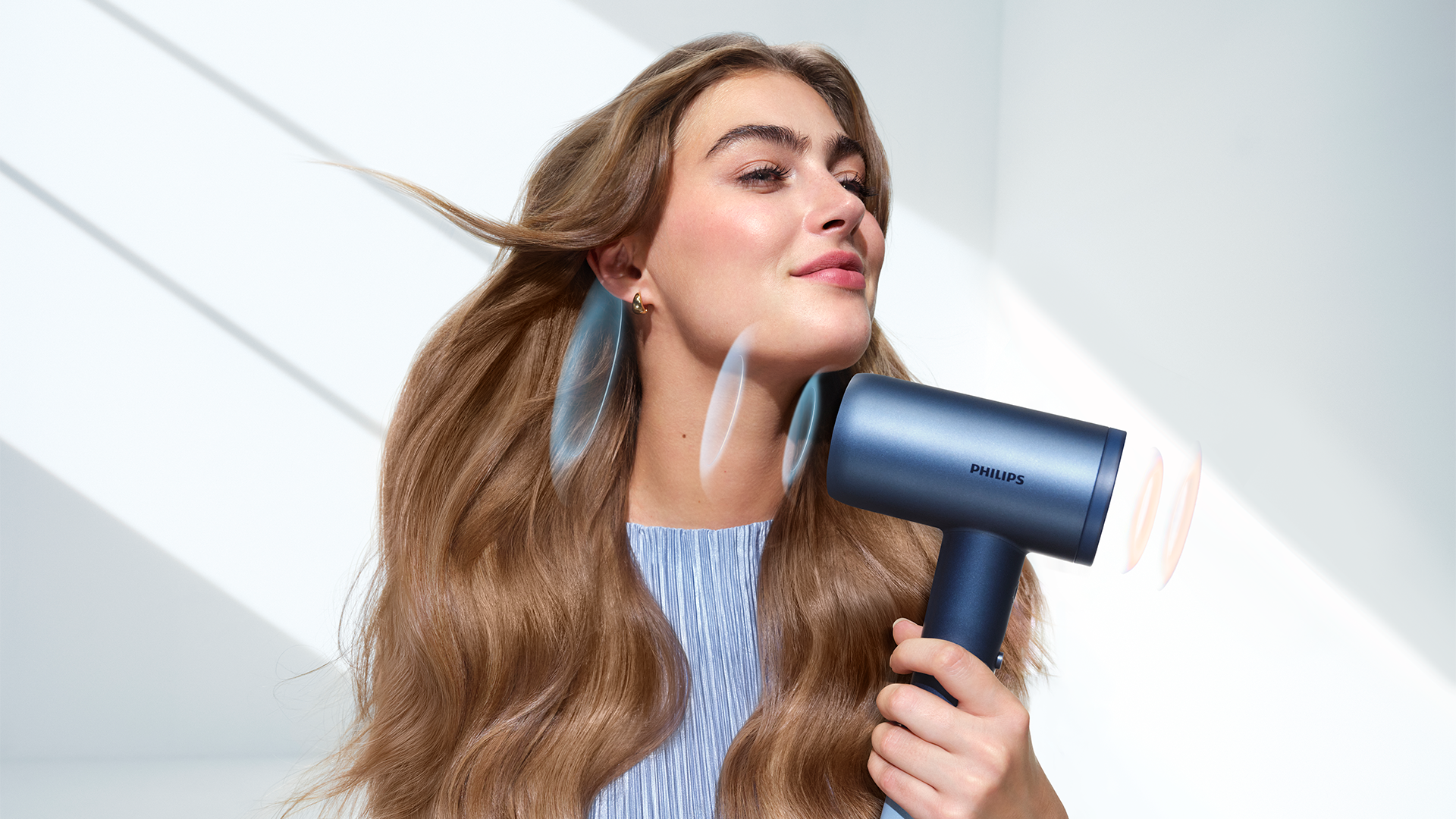 Hair dryer featuring intelligent sensors to actively monitor and adapt airflow temperature