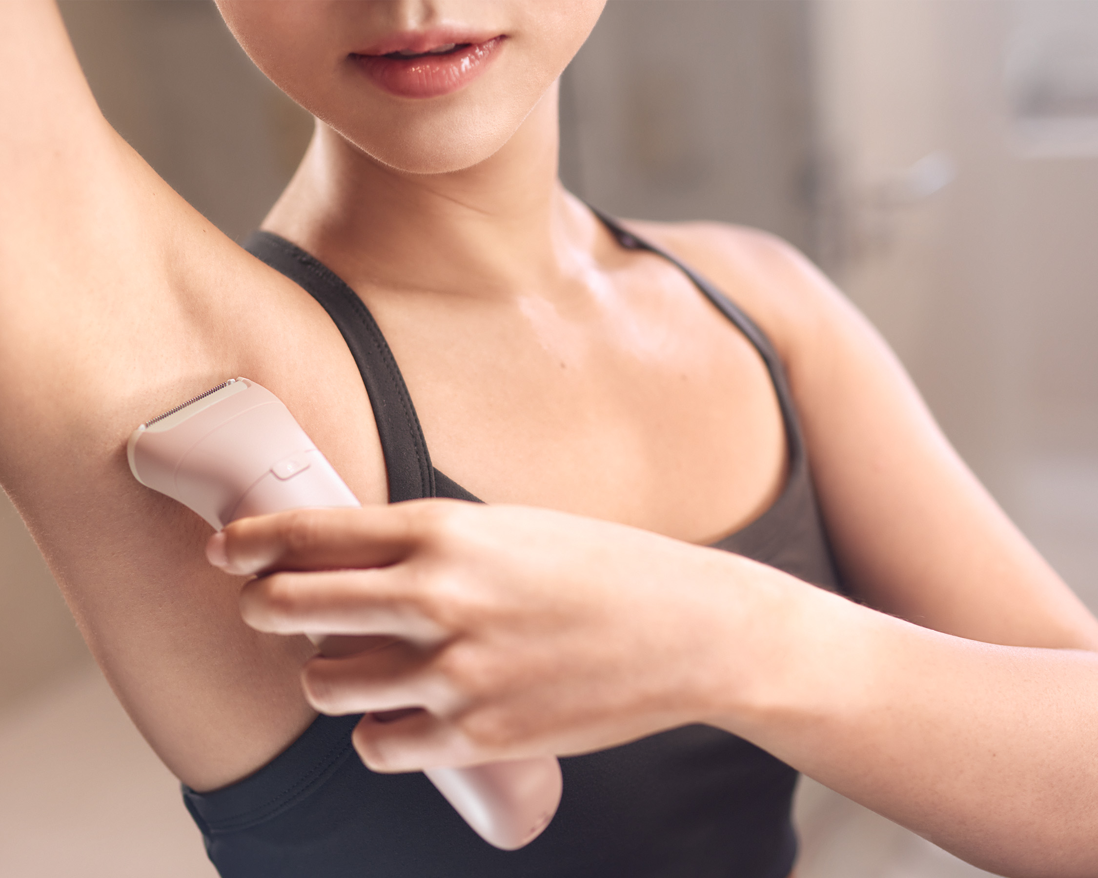 Lady is shaving her underarm