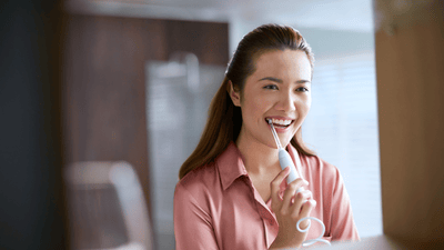 woman using Philips Power Floss