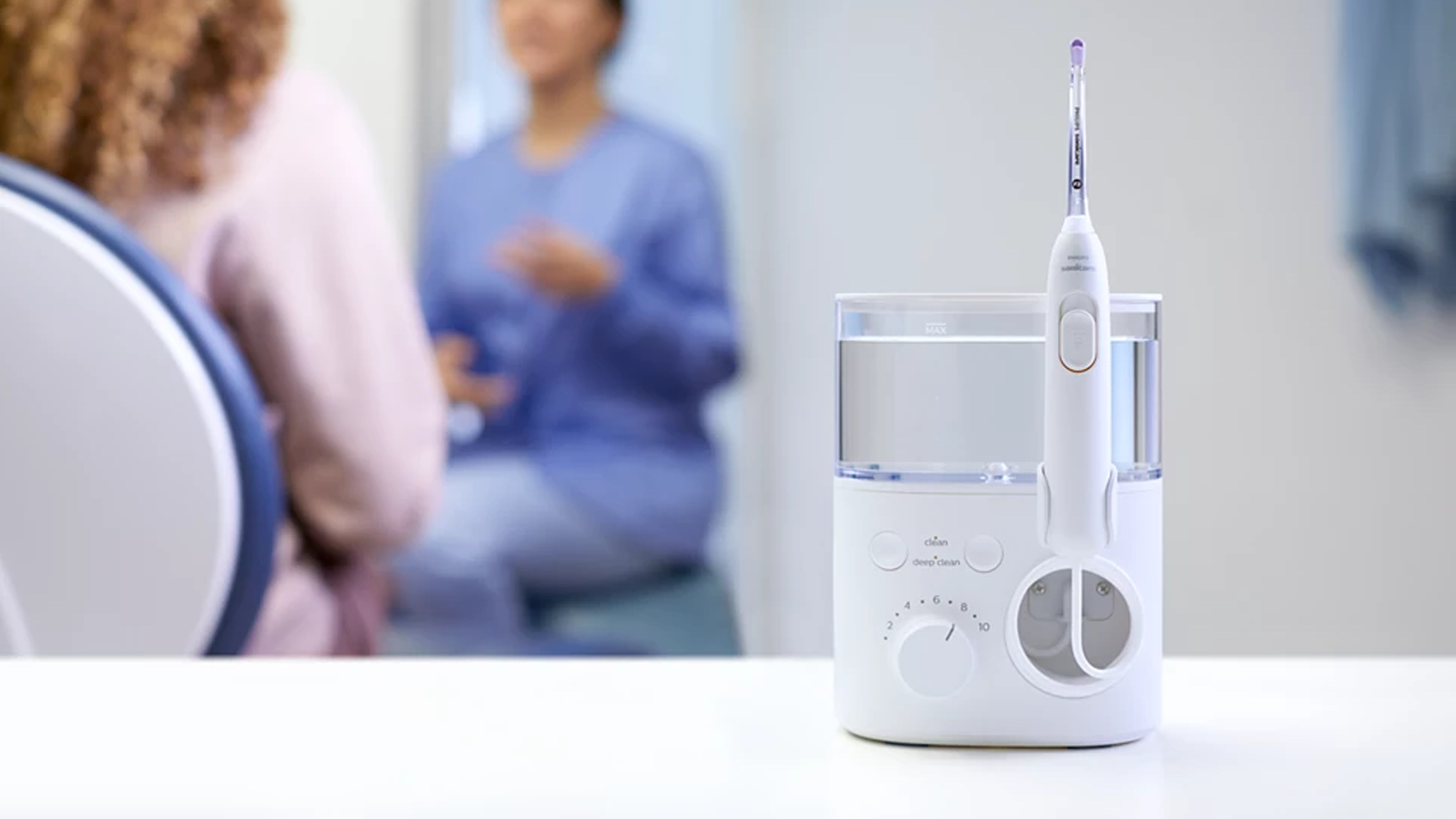 A Philips Sonicare Cordless Power Flosser being held.