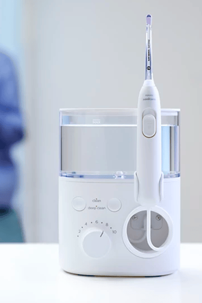 A Philips Sonicare Cordless Power Flosser being held.