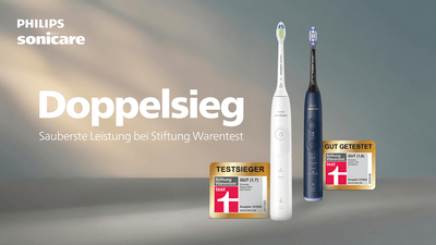 Two Philips Sonicare electric toothbrushes stand side by side against a gradient background